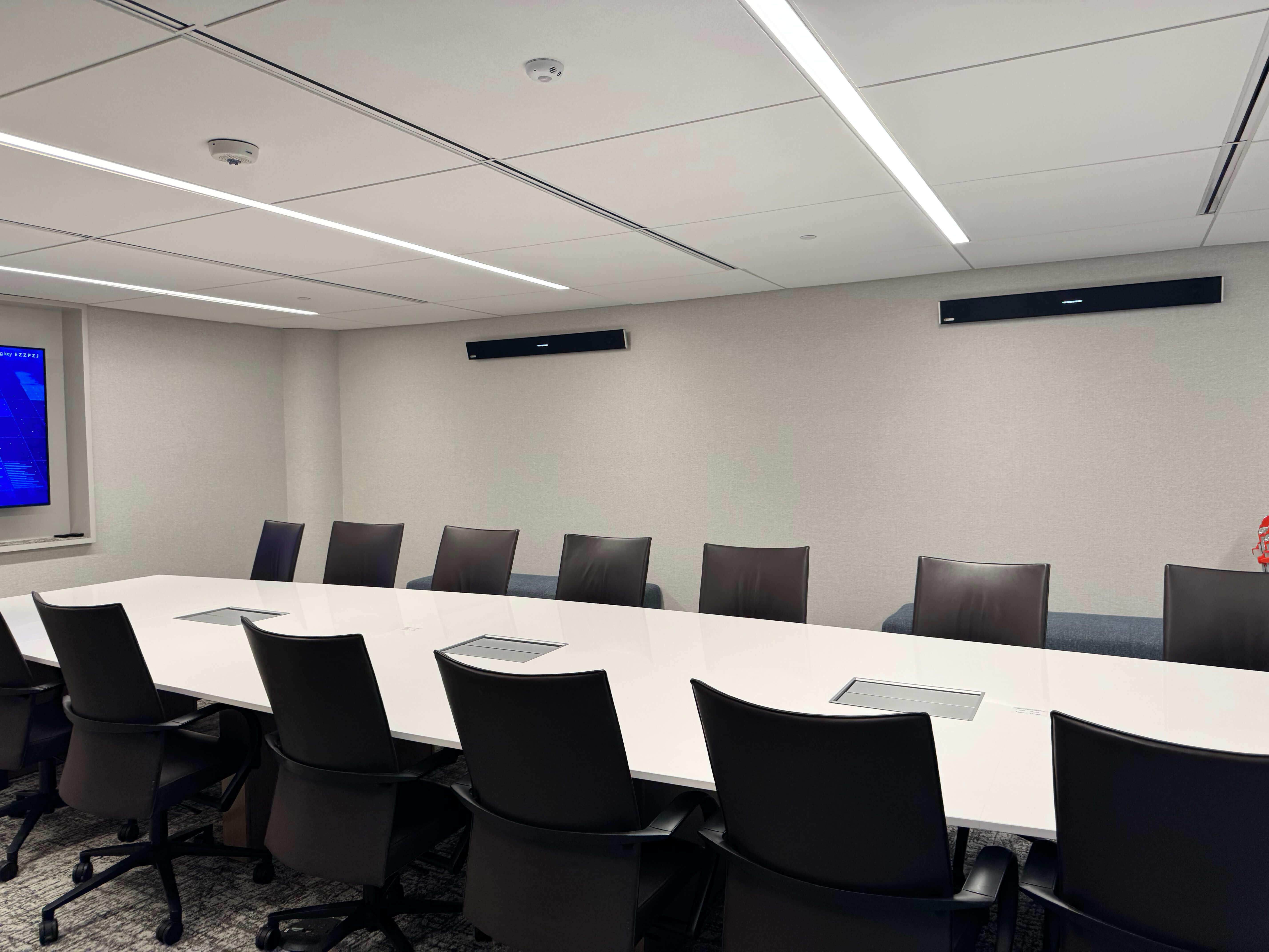 Law firm boardroom with videoconferencing display and marble conference table