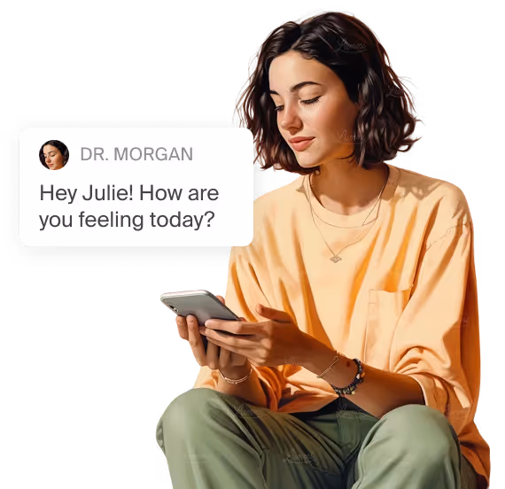 A woman sitting on a chair looking at a cell phone.