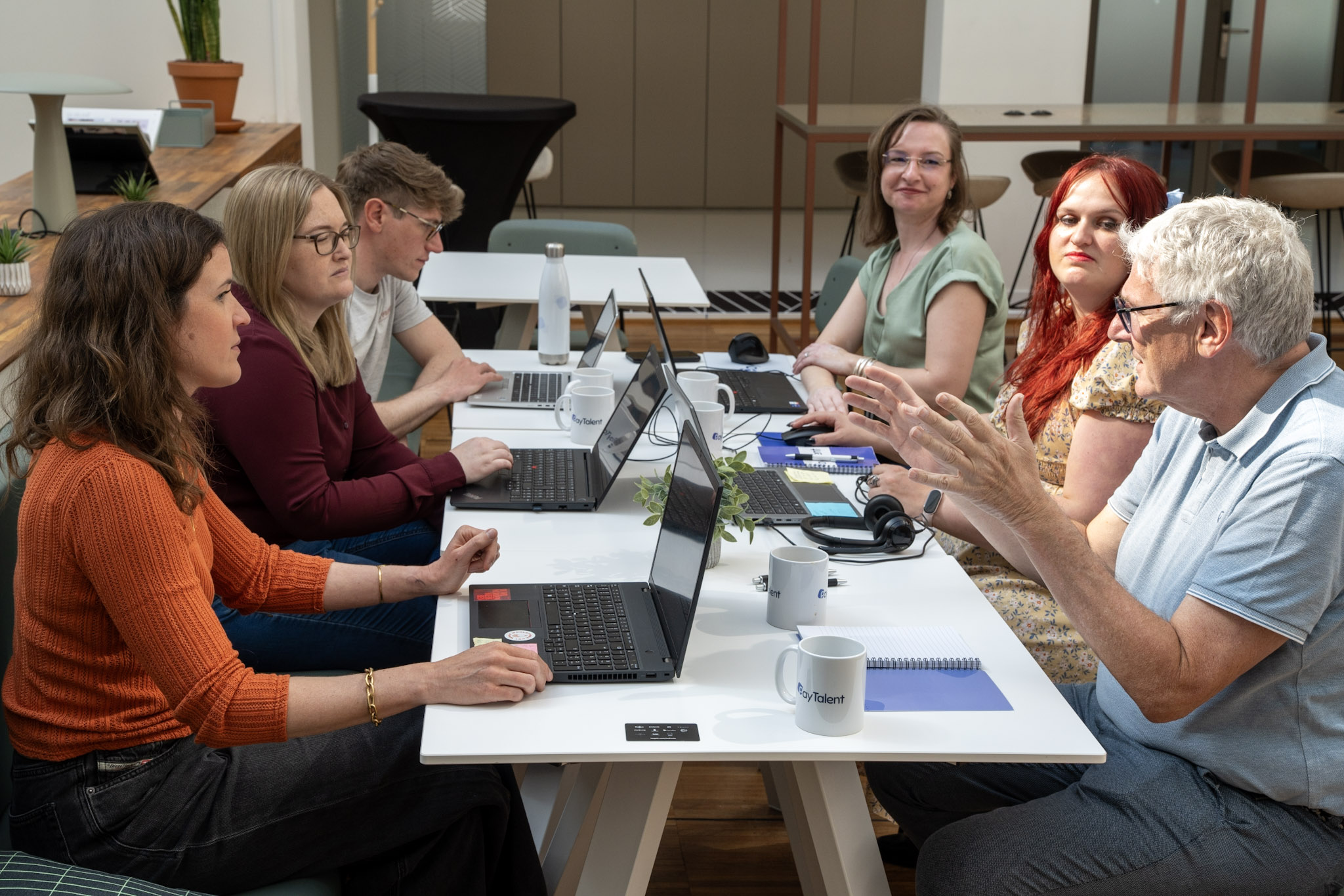 Team of people looking at a computer screen.