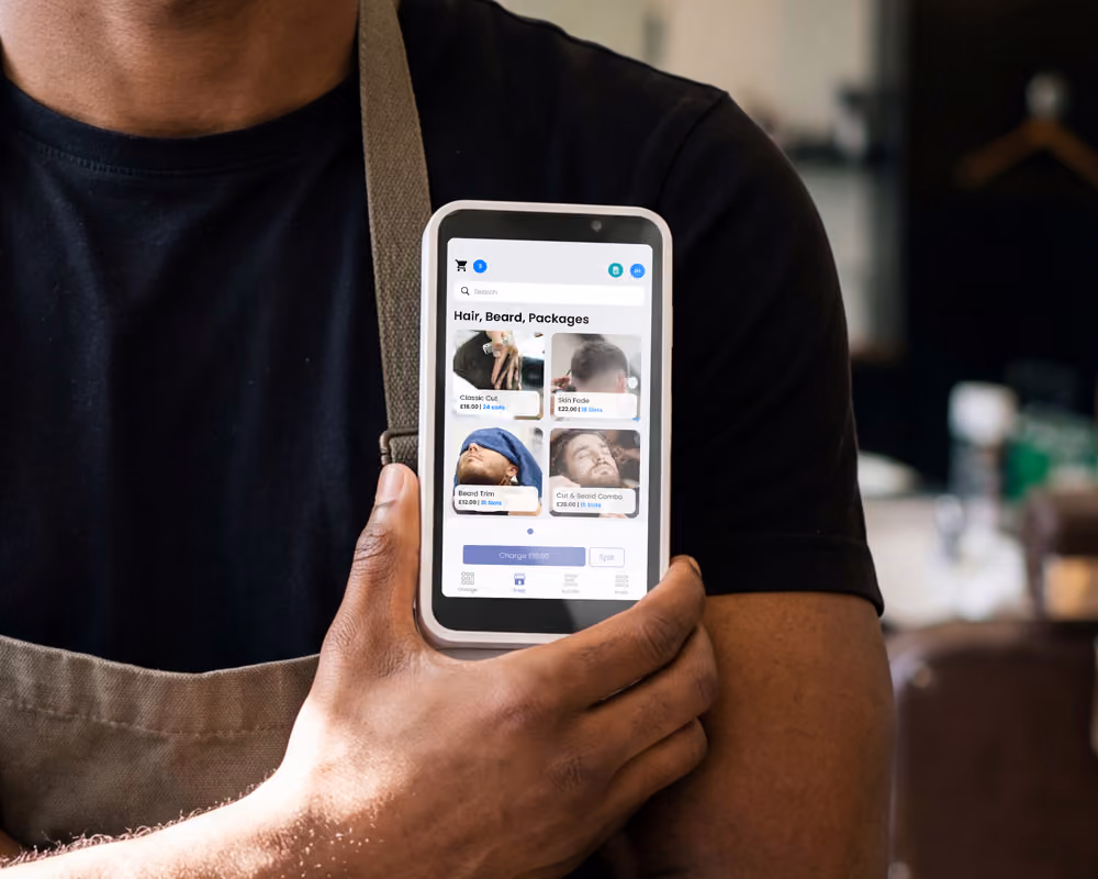 A barber using Lopay's POS system, with tools to take payments and manage their business in one place.