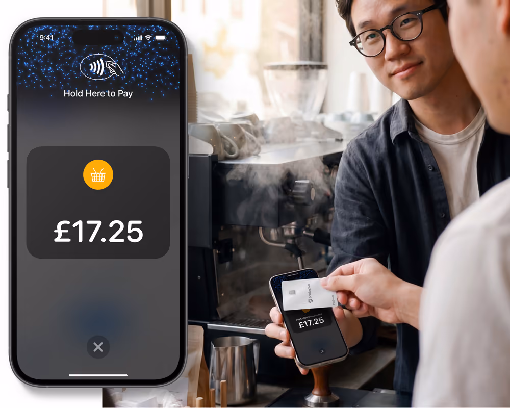 A merchant using Tap to Pay on their smartphone to accept a contactless payment from a customer.