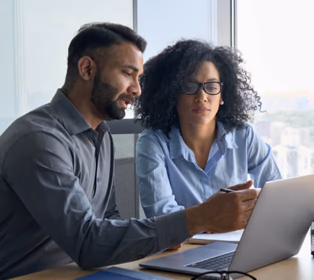 Man show women something on laptop screen