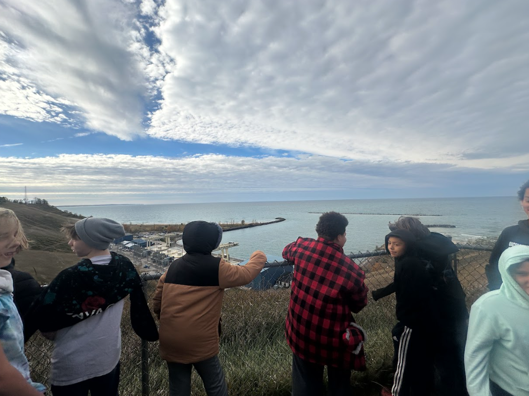 Students looking at windmills in the distance.