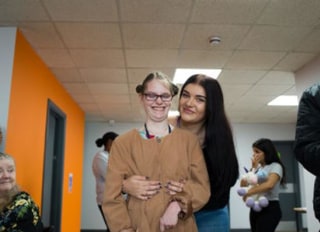 Two Aston Transitional Care team members smiling together