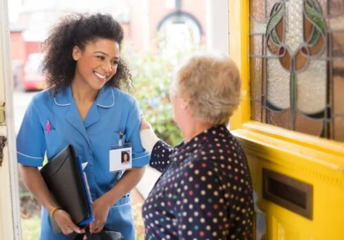 A RedJacket Specialist Care worker visiting an older woman at home