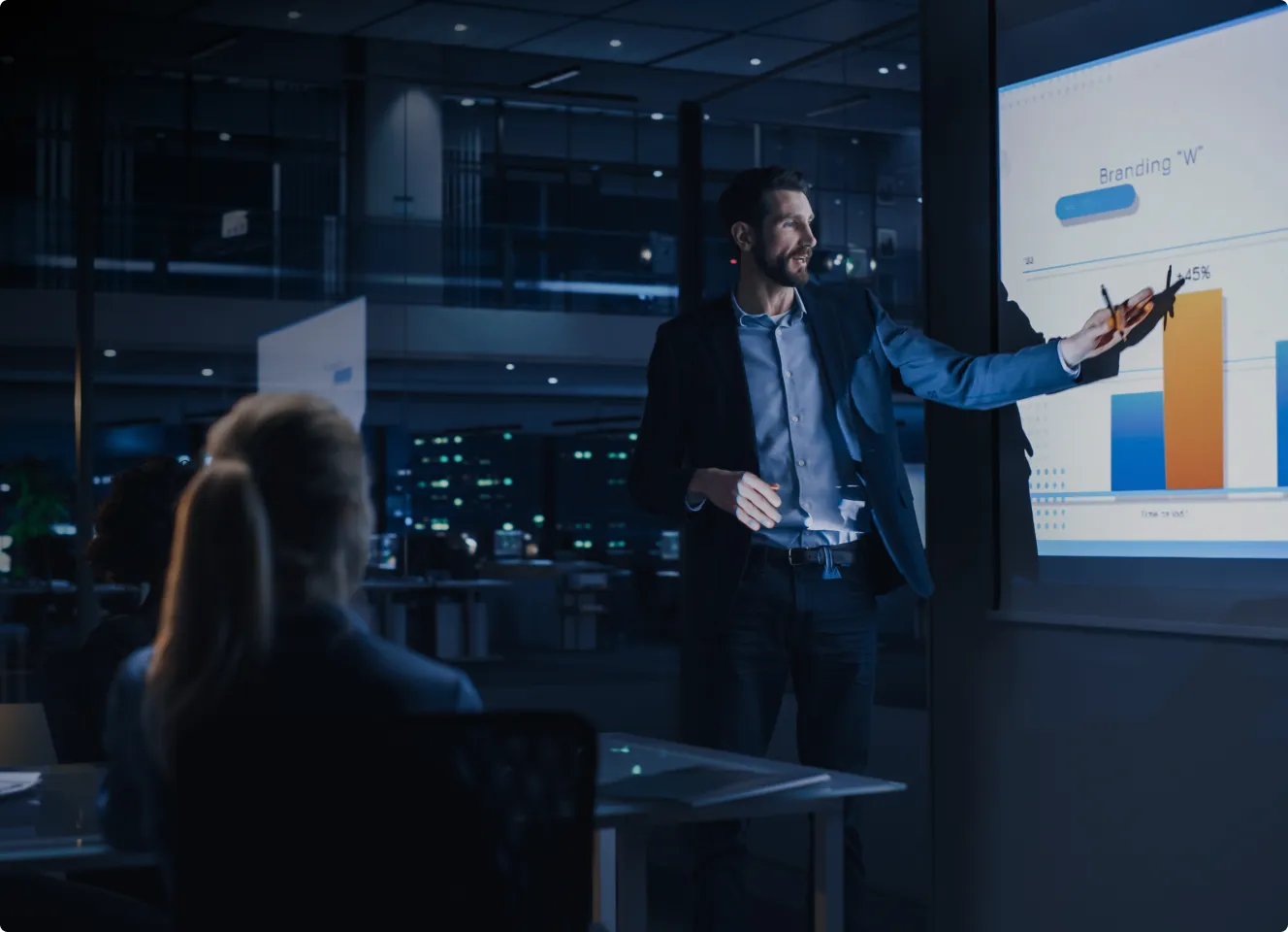 man presenting charts on projector.