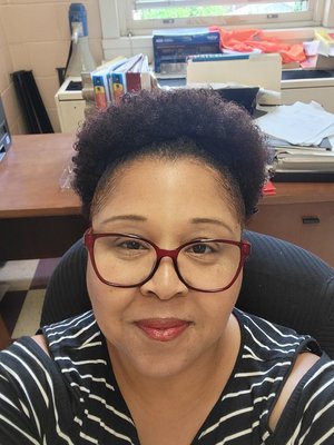 Ms. Green smiling in her school office