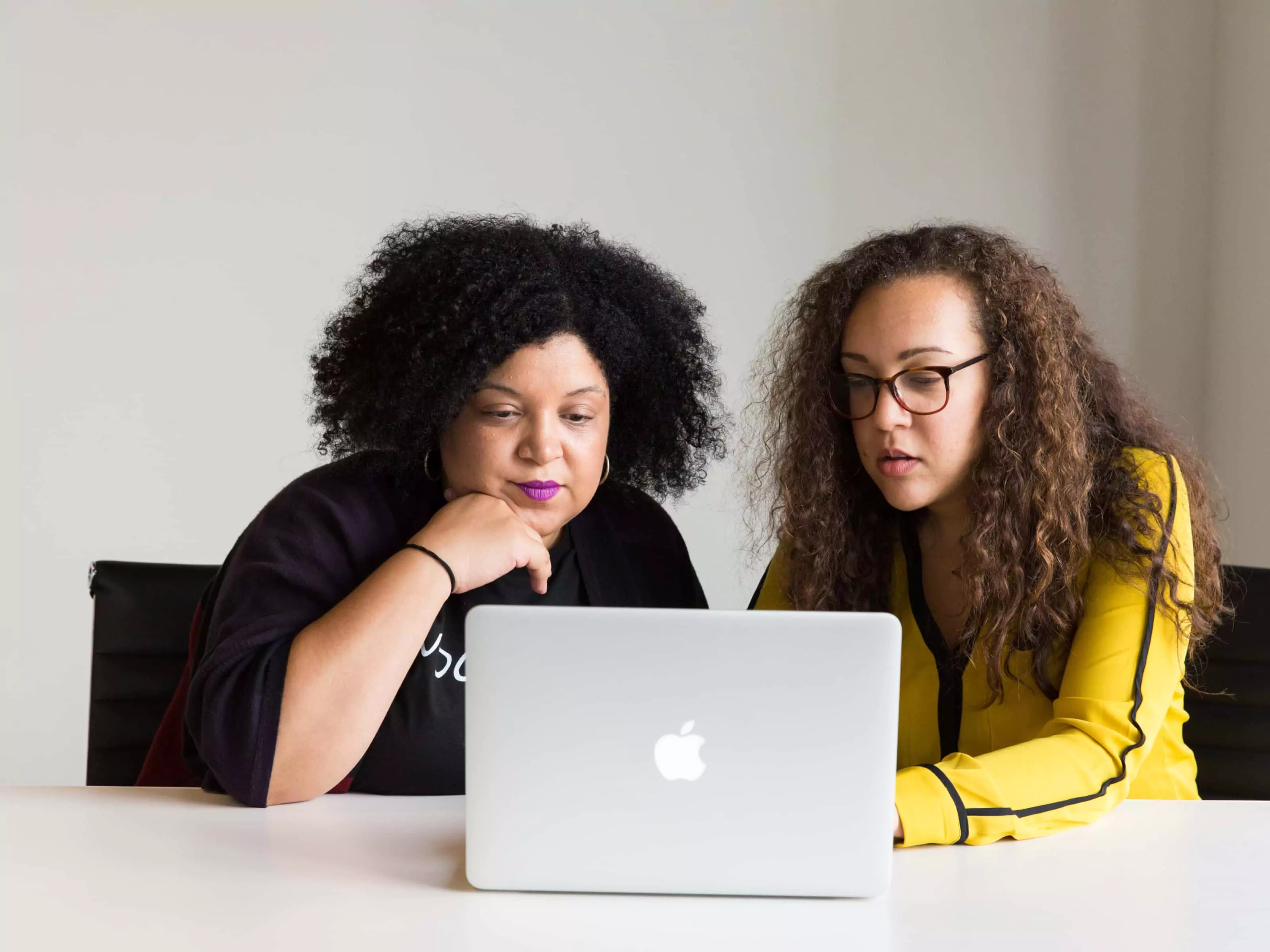 Two women in front of a laptop