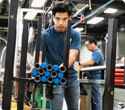 young gentleman working with some pipe and tubes at Lincoln Plastics