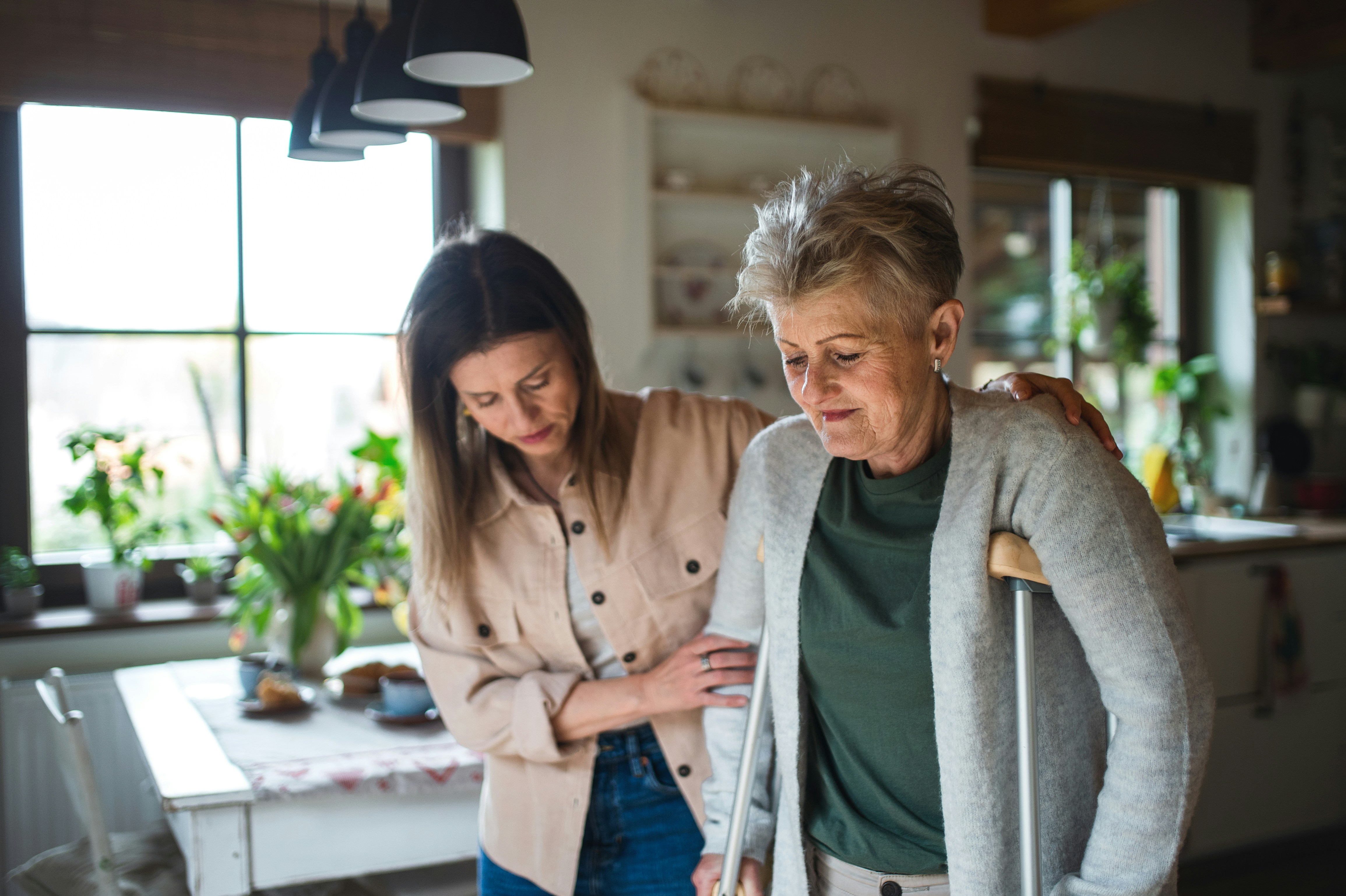 A volunteer helping elderly woman to prevent falling
