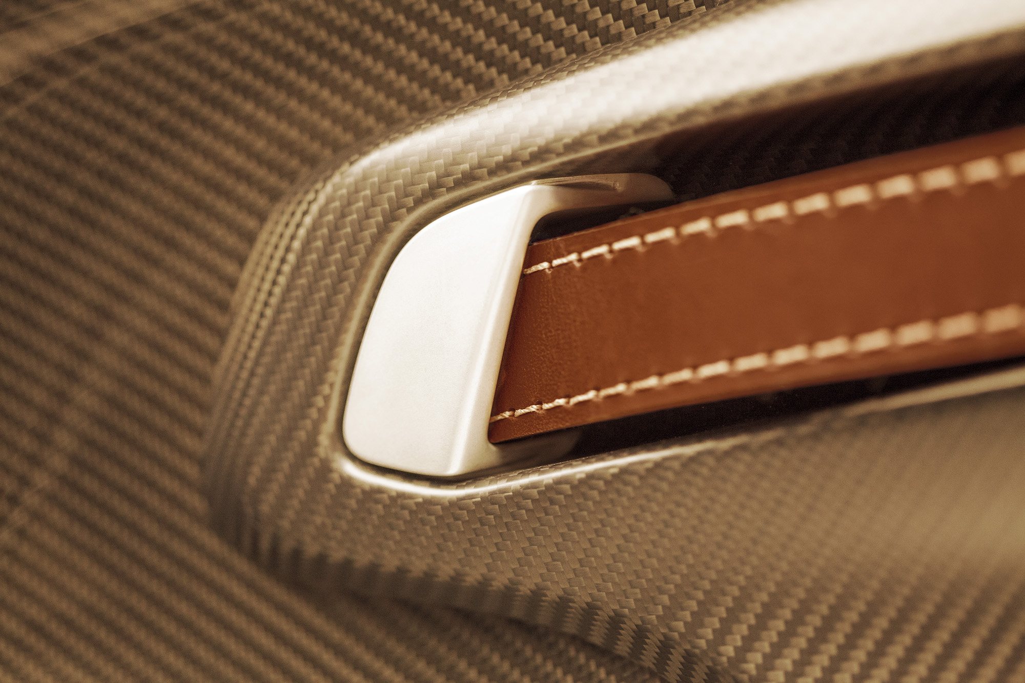 Hand-stitched leather and carbon fibre detail on the included Aston Martin