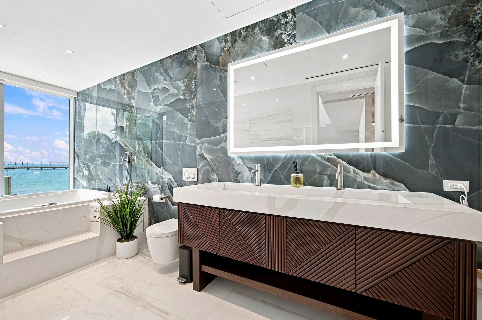 Open kitchen and living area with city views — Residence 301