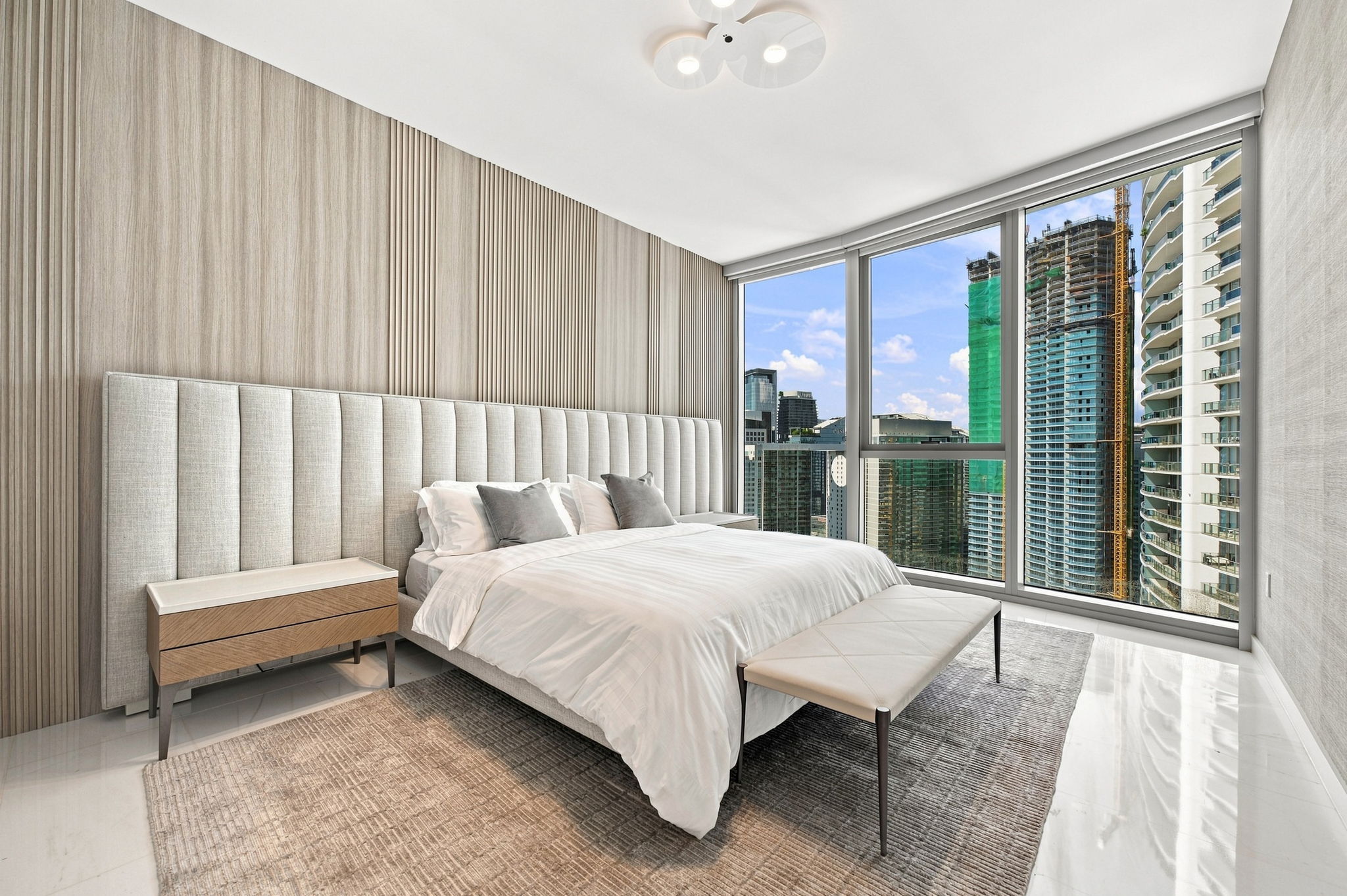 Primary bedroom with floor-to-ceiling city views — Residence 3807