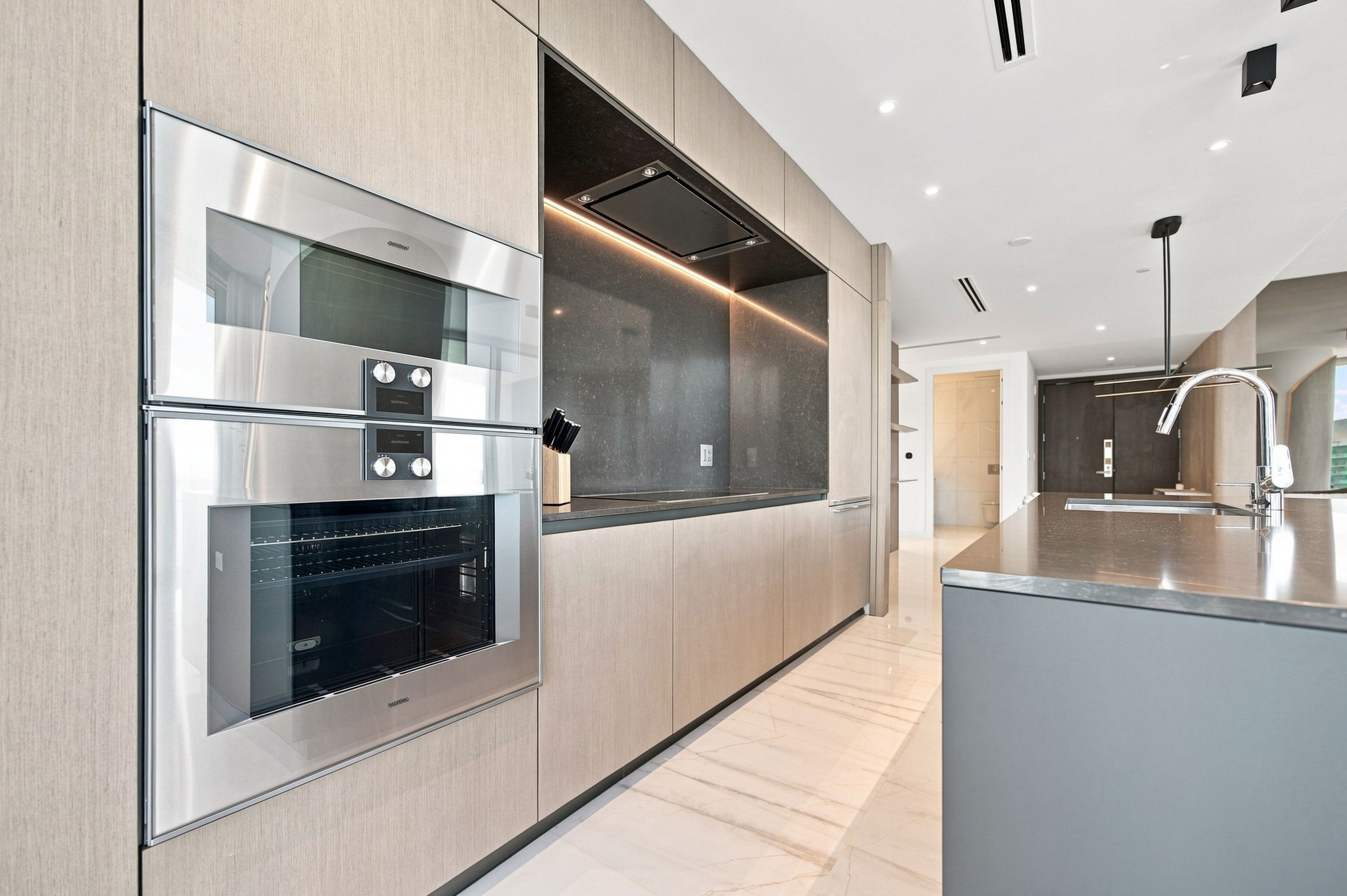 Kitchen appliance wall and hallway — Residence 3807