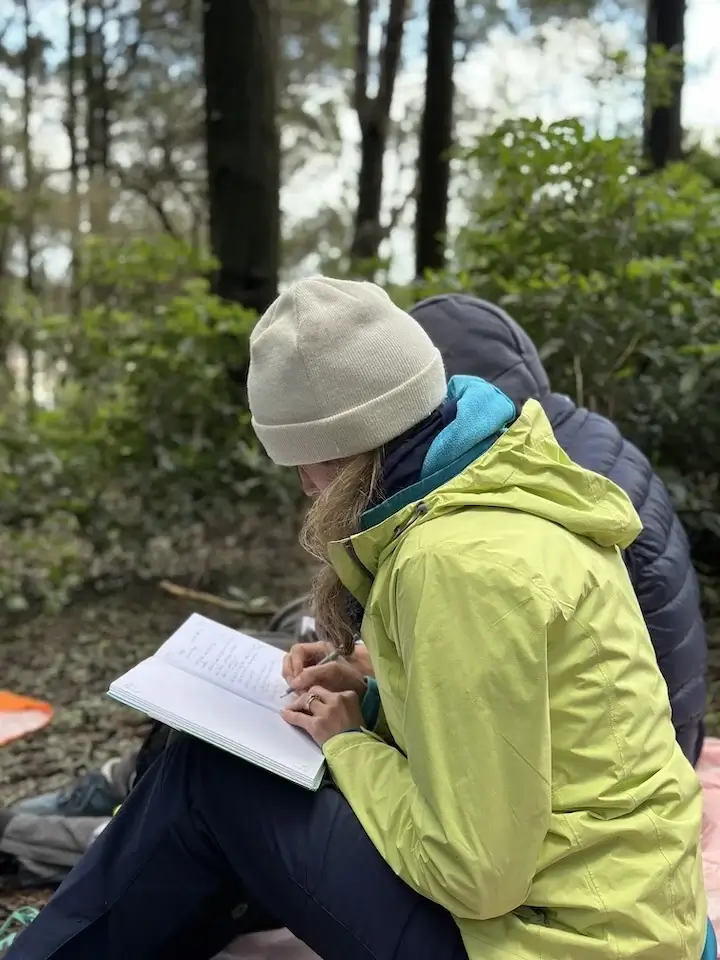 Silhouette of an anonymous participant journaling, symbolising joy, connection, and the unforgettable, magical experience of Martin Thomsen’s guided ceremony walk.
