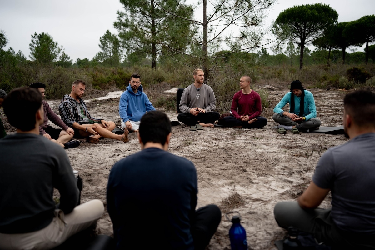 The circle of men seated on mats in a forest clearing at The Return of Men retreat, Wim's Land, Comporta, November 2024.