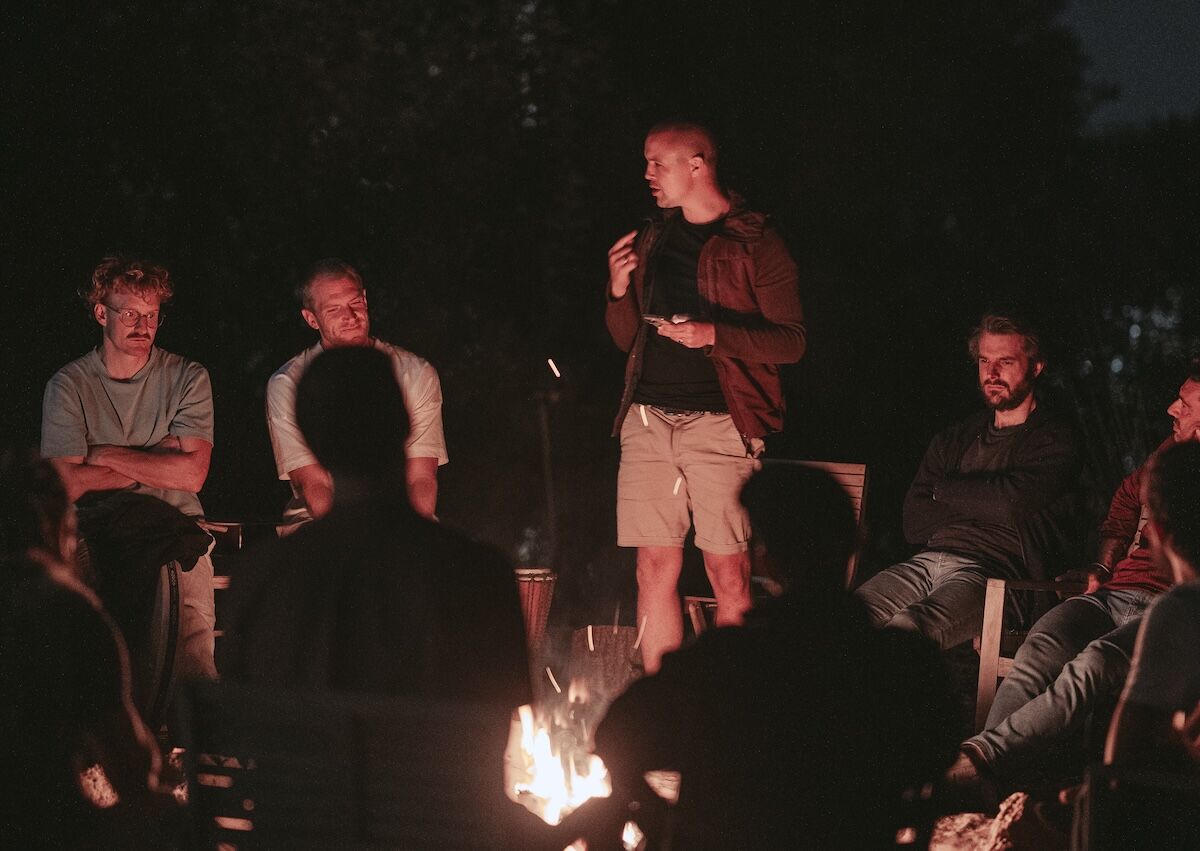 Martin Thomsen speaking to the men by firelight at night during a men's retreat in Arrábida, Portugal