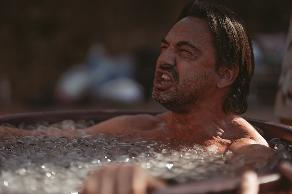 Man sitting in an ice bath, focused and composed, symbolising emotional intelligence and inner strength.