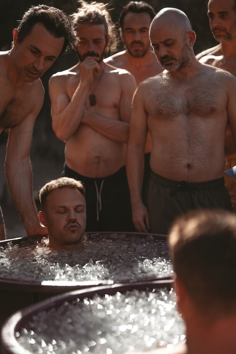 Entrepreneur sitting in an ice bath, calm and focused — representing the clarity, resilience, and emotional balance cultivated through mindful microdosing practices.