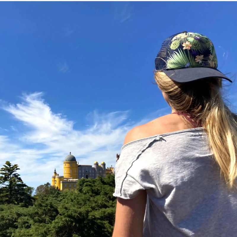 Anna looking at Pena Palace in Sintra surrounded by trees and blue skies, reflecting clarity, gratitude, and transformation from Martin Thomsen’s guided ceremony walk.