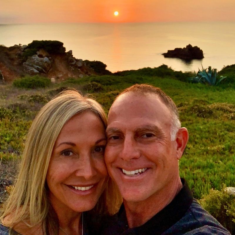 Ken and Clover Ryan smiling in a sunset selfie by the ocean in Portugal, reflecting joy, renewal, and purpose after Martin Thomsen’s retreat.