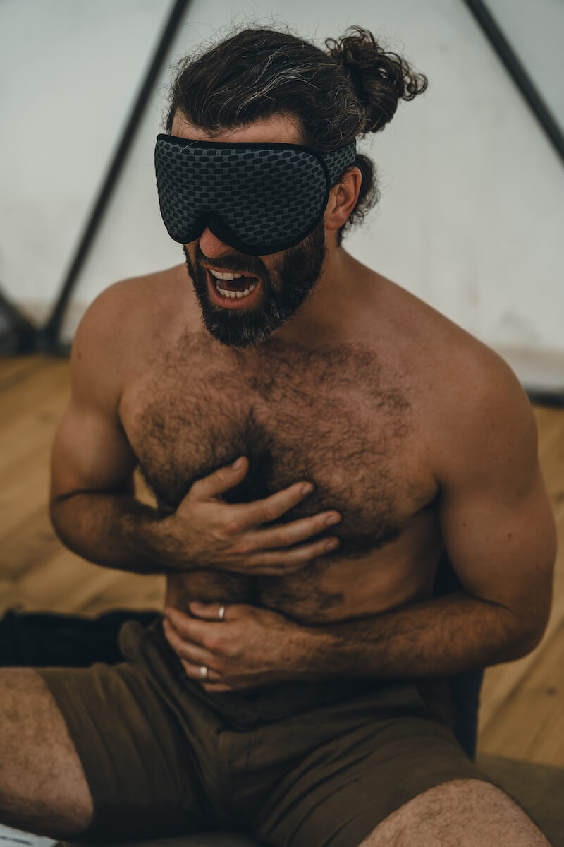 A blindfolded man cries out with hands pressed to his chest at The Return of Men retreat, Portugal, May 2026.