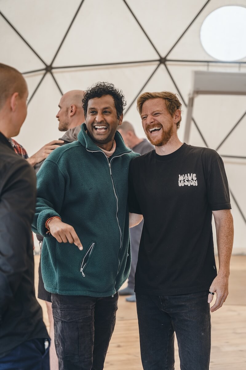 Two men crack up laughing together in the dome at The Return of Men retreat, Arrábida, May 2026.