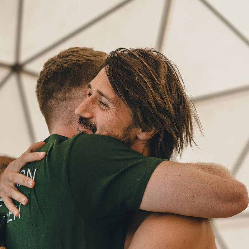 Men smiling with clarity and strength after the Return of Men Retreat, reflecting healing, brotherhood, and renewed purpose.