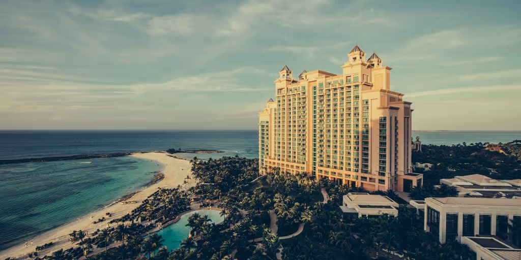 yellow concrete building beside body of water