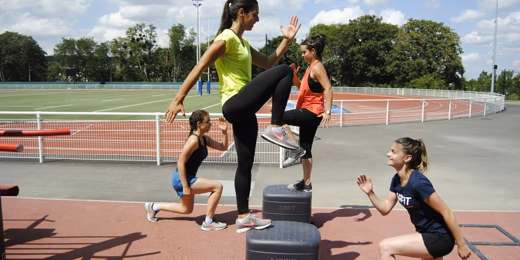 woman in green tank top and black shorts doing yoga during daytime