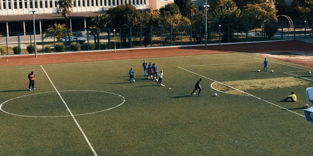 people playing soccer on open field