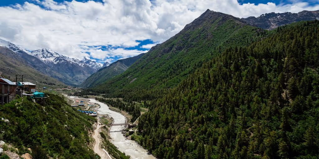 a river running through a lush green valley