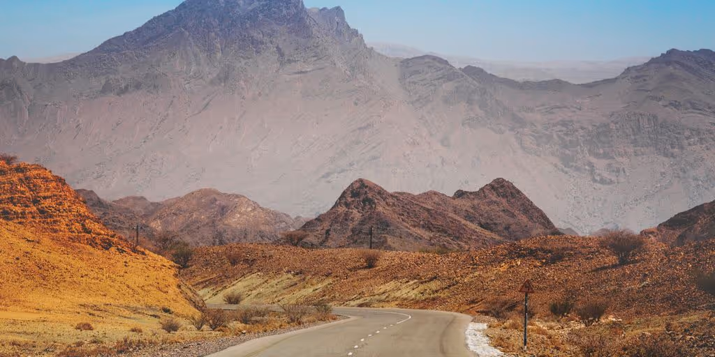 curved road surrounded by mountains
