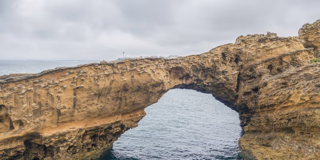 a large rock bridge over a body of water