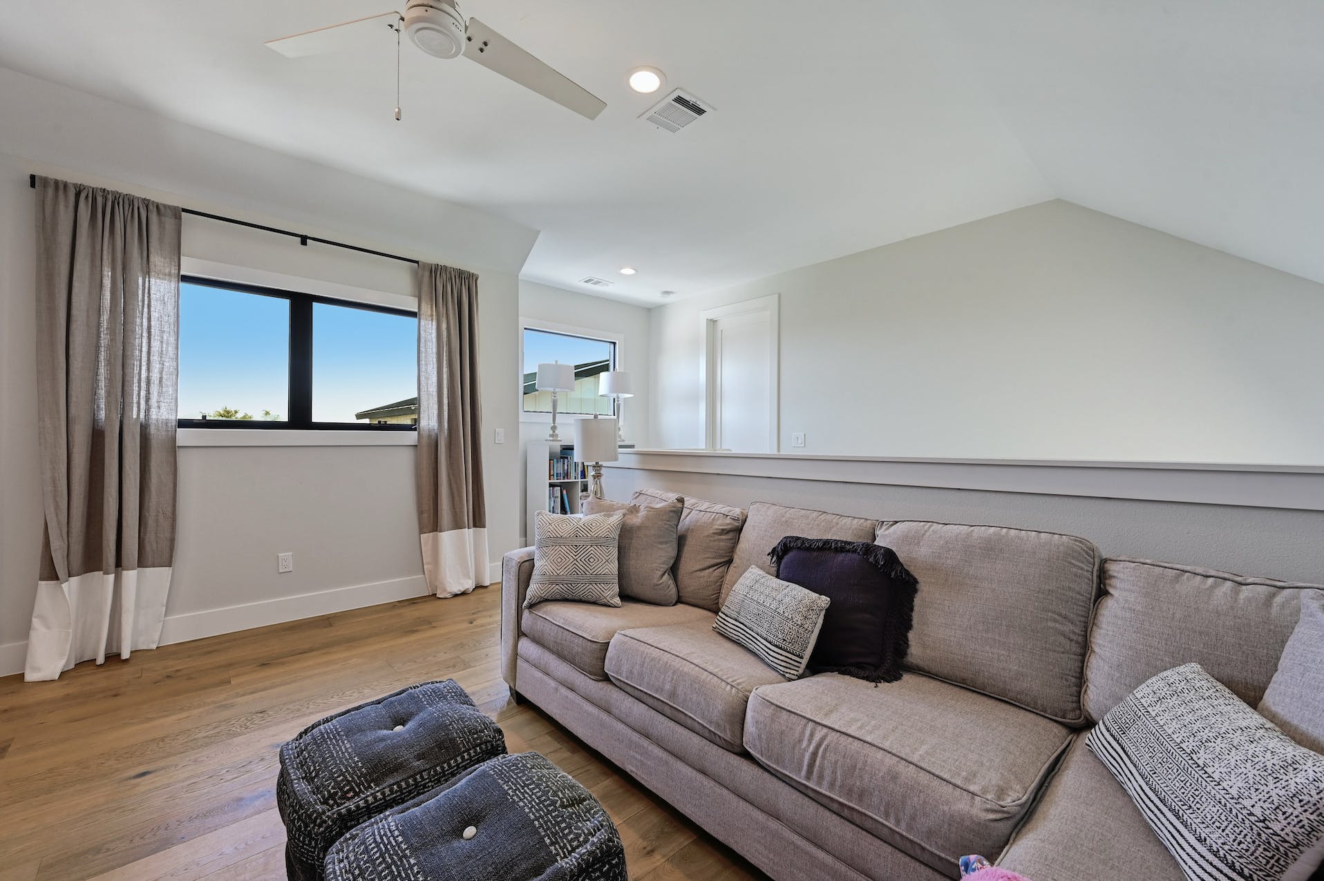 Family room with a sectional sofa under a sloped ceiling