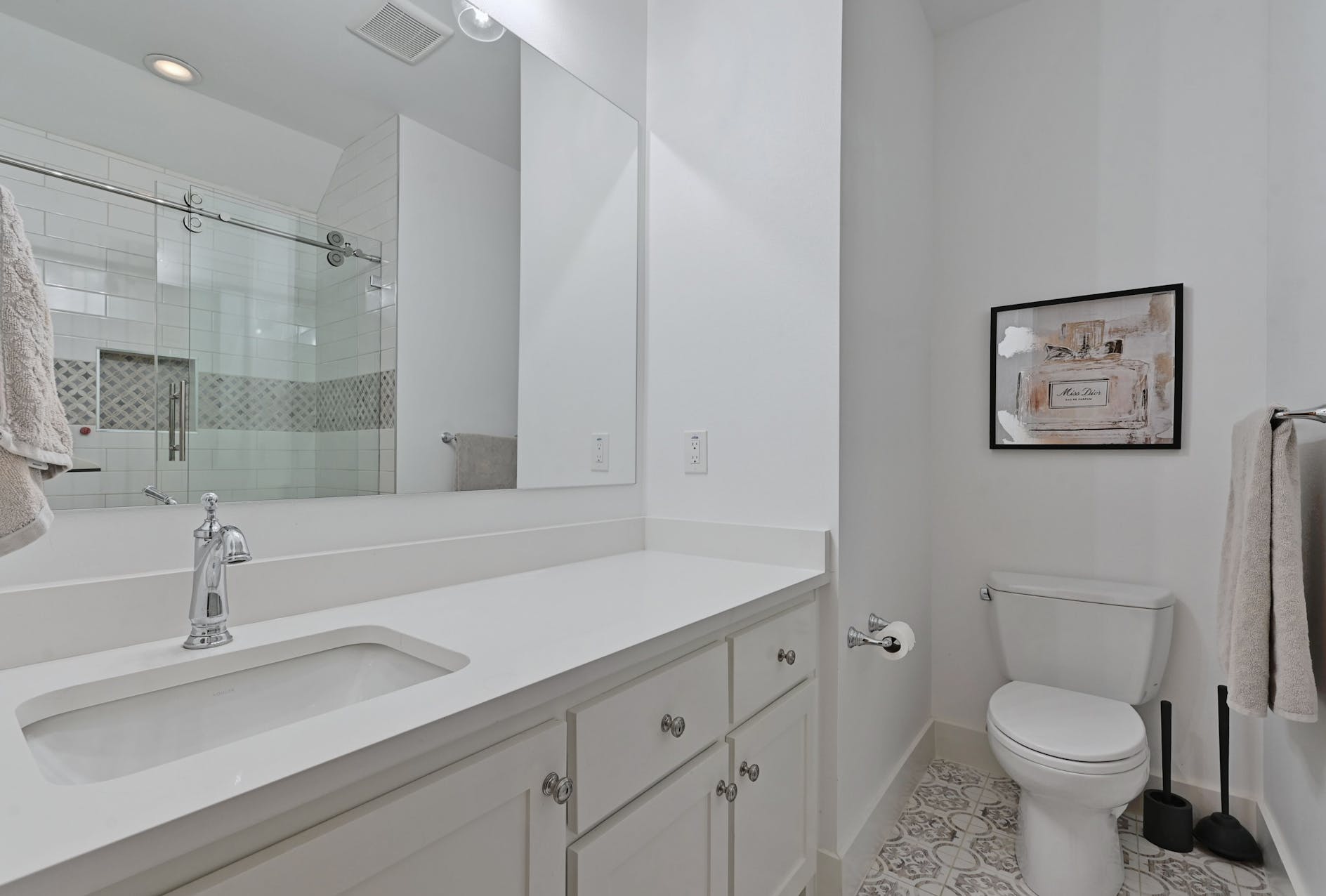 Bathroom with a white vanity and glass shower