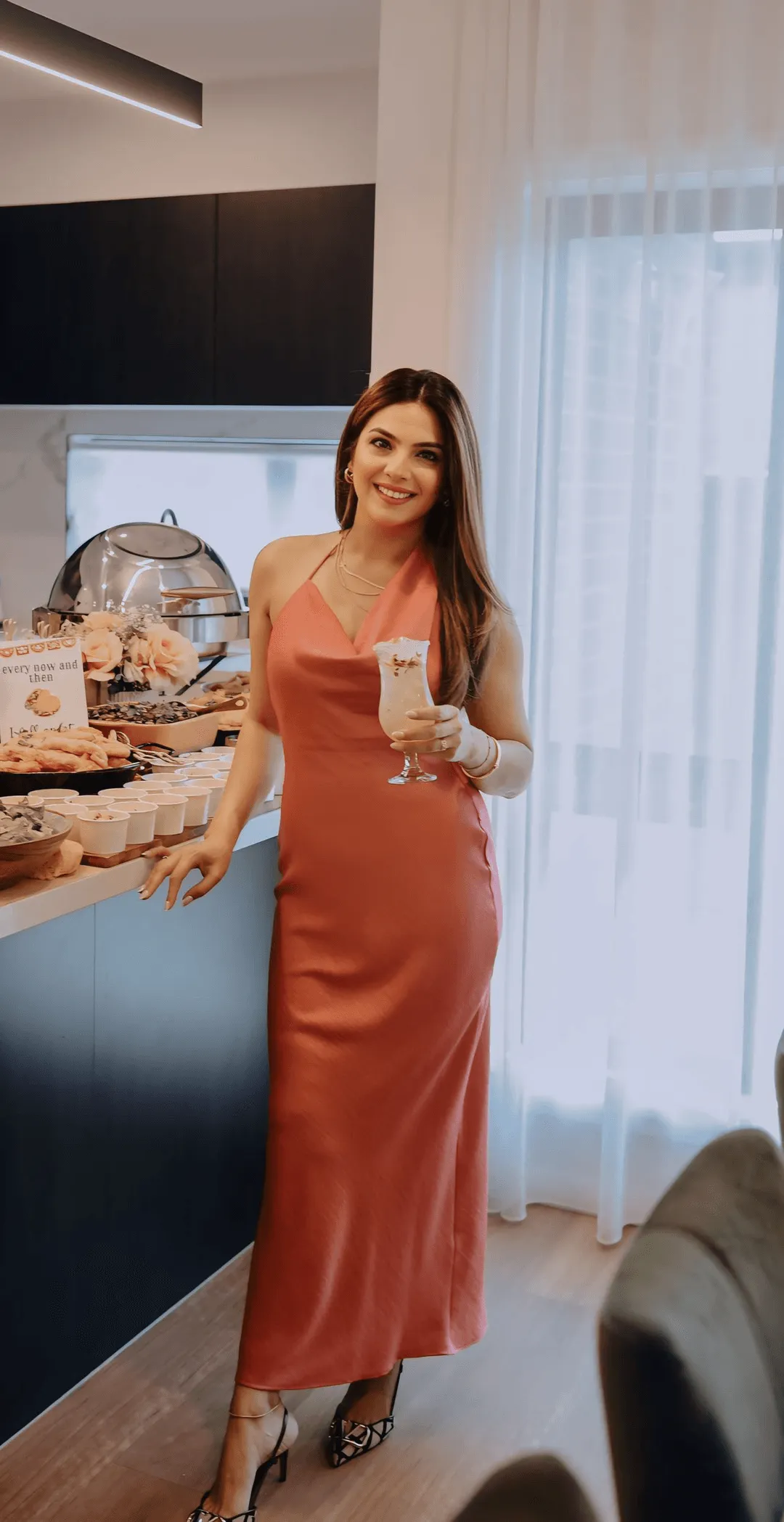 Guest with a mocktail beside a styled display
