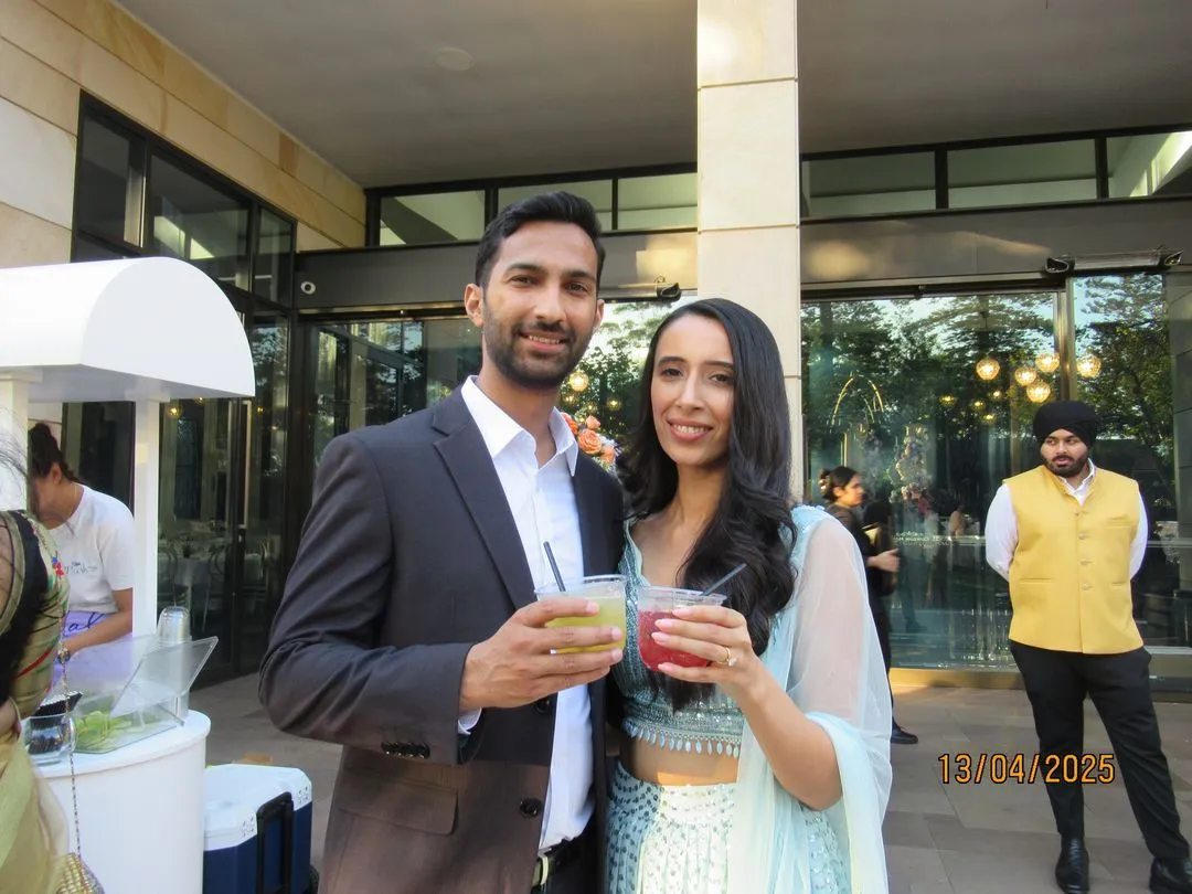 Guests in traditional dress with mocktails at a cultural celebration
