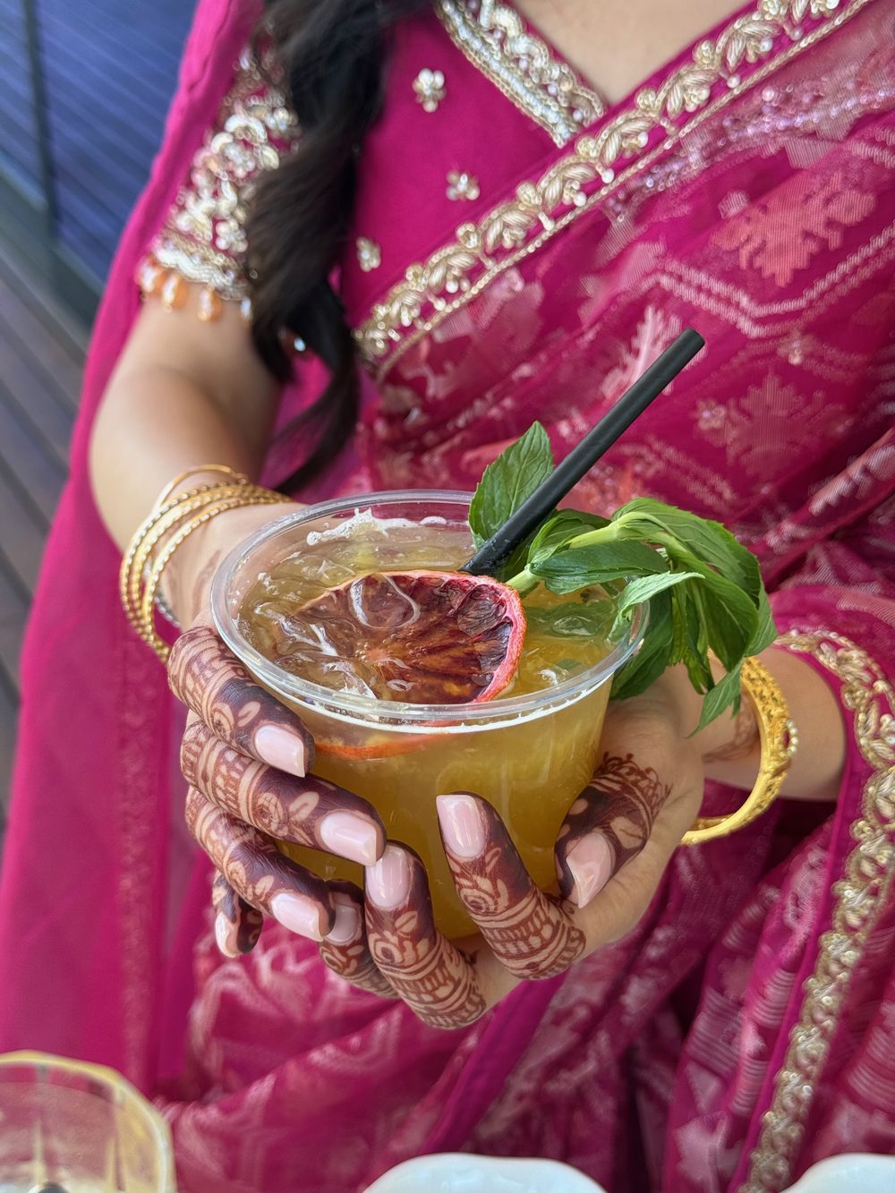 Guest holding a mocktail on a wedding day