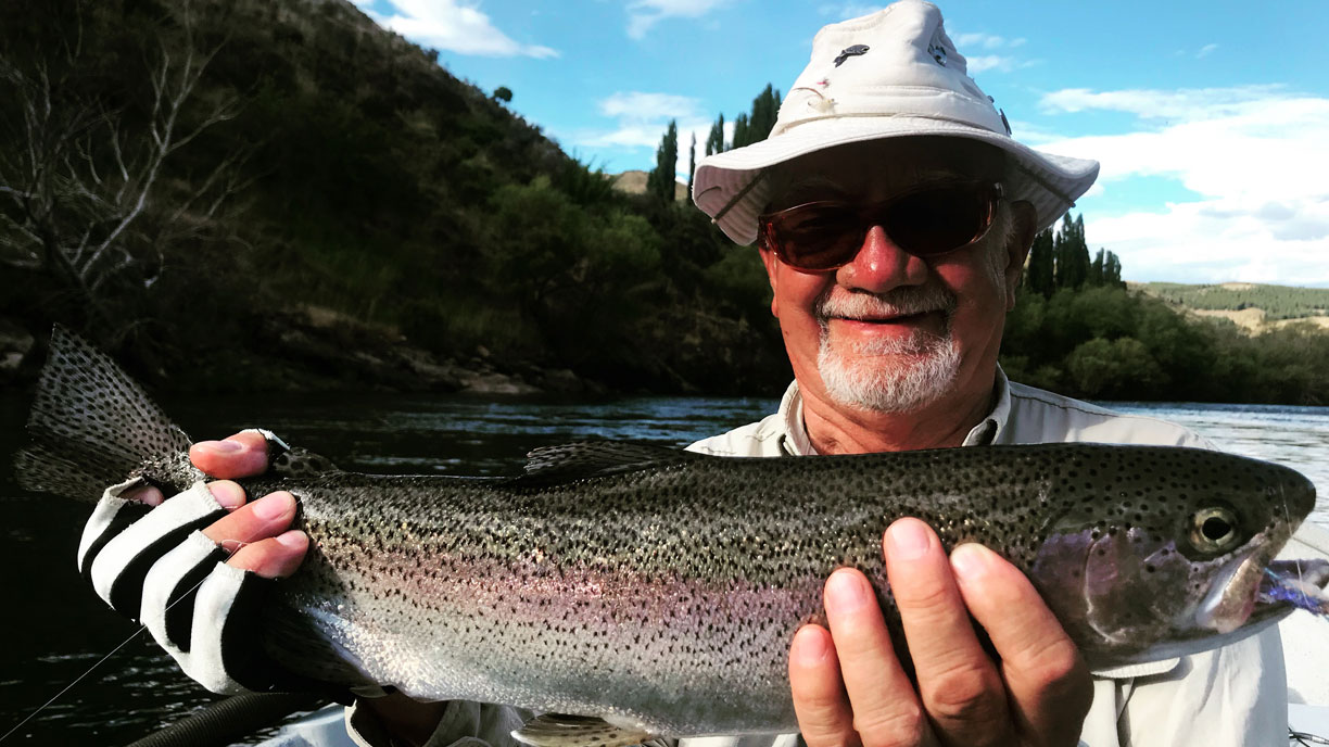 Angler with a rainbow trout catch in Northern Patagonia at Bravo Sur Lodge