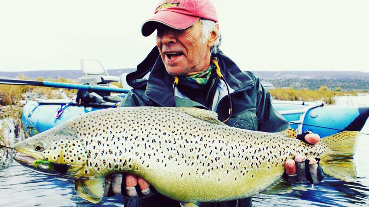 Guest with a trophy brown trout at Bravo Sur Lodge