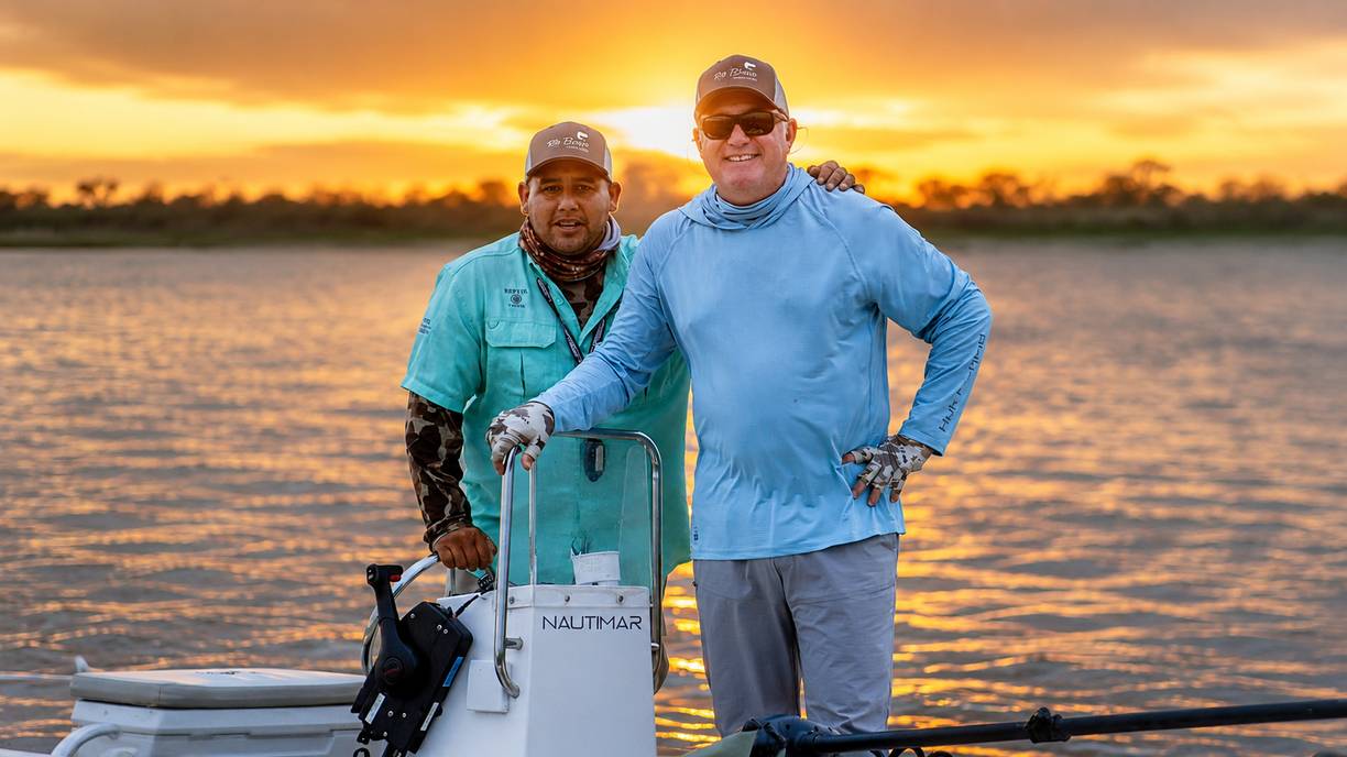 Fishing guide and guest at sunset on the Paraná at Rio Bravo Lodge
