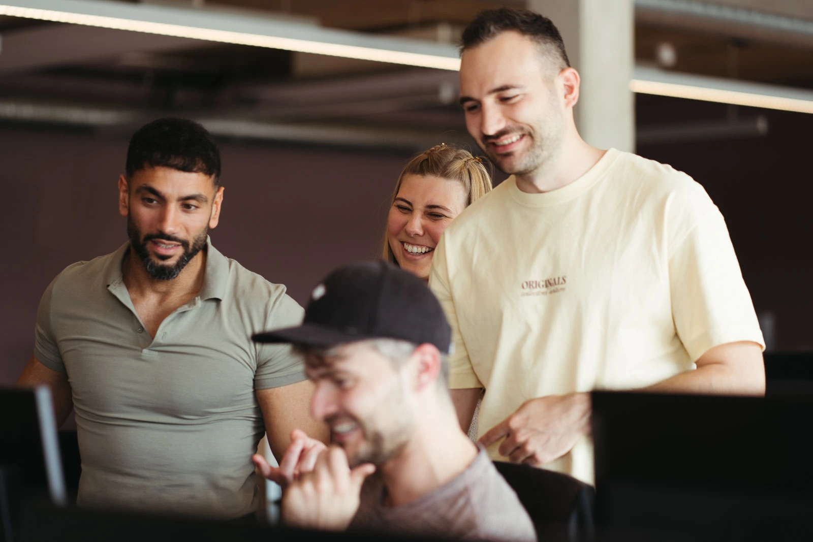 Employee explains something which seems to be funny because people are laughing