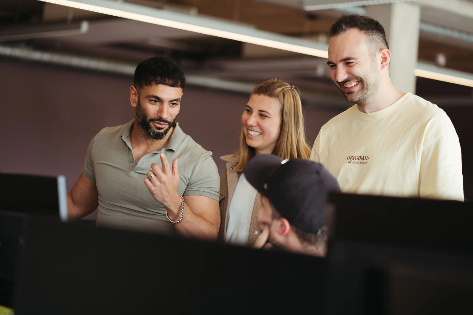 Employee explains something which seems to be funny because people are laughing