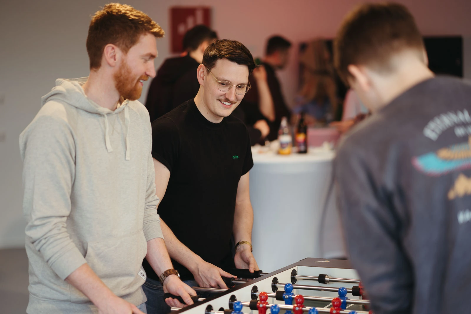 Employees enjoy lunch break playing soccer at a table
