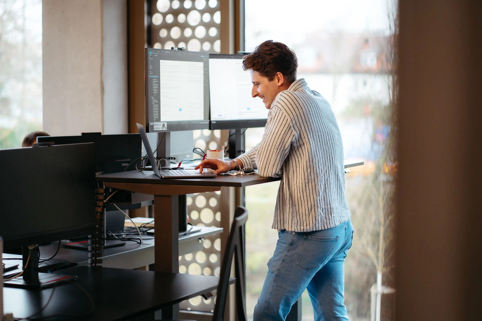 Employee working at a standing desk