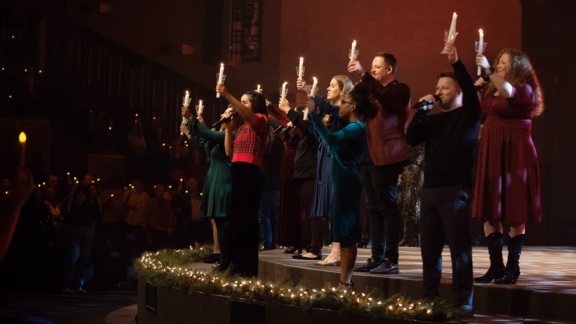 Worship team holding candles at Christmas Eve