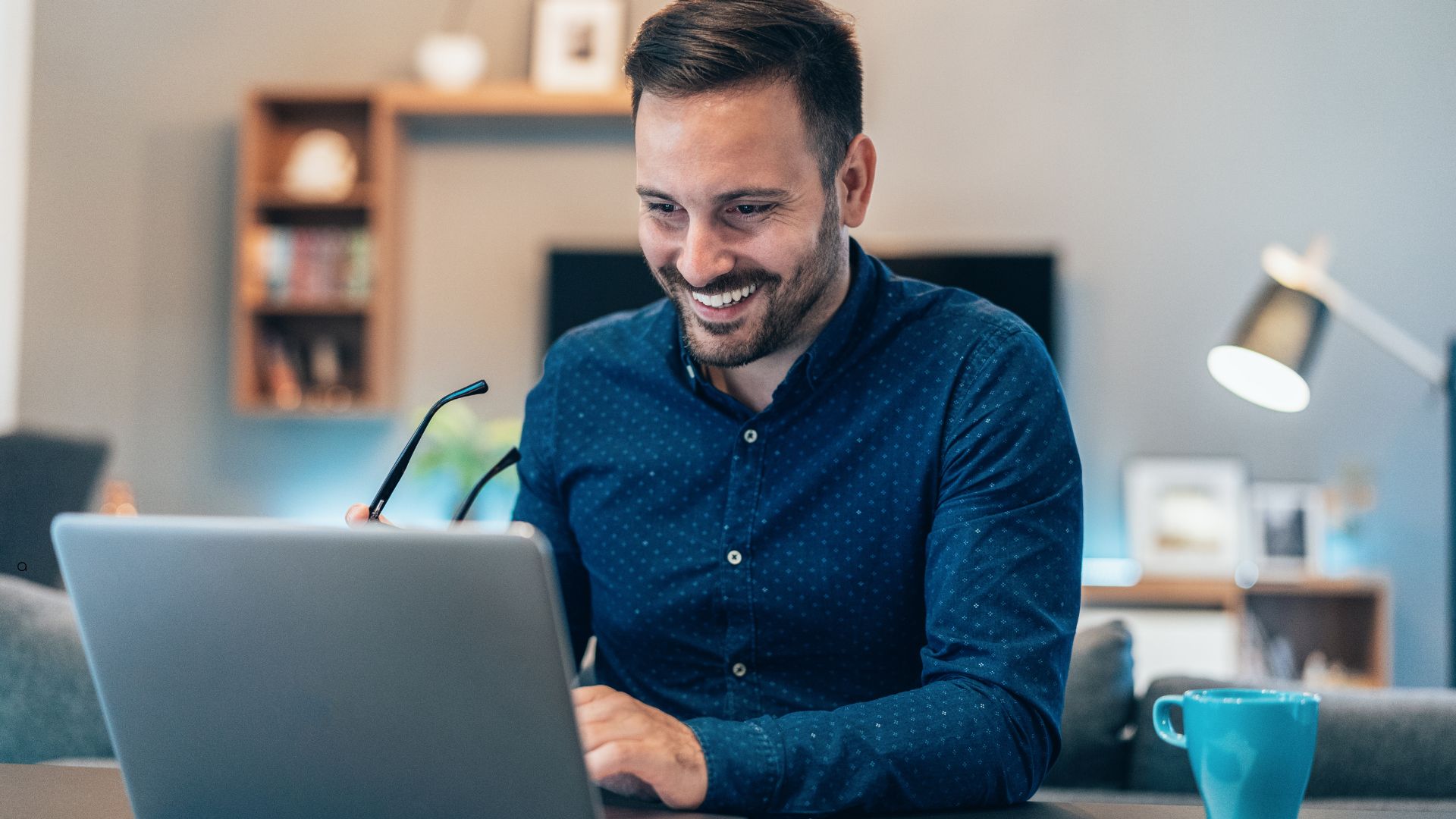 A Worker smiling at his Laptop