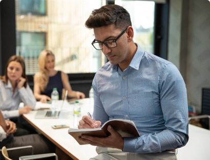  a worker looking through a workbook