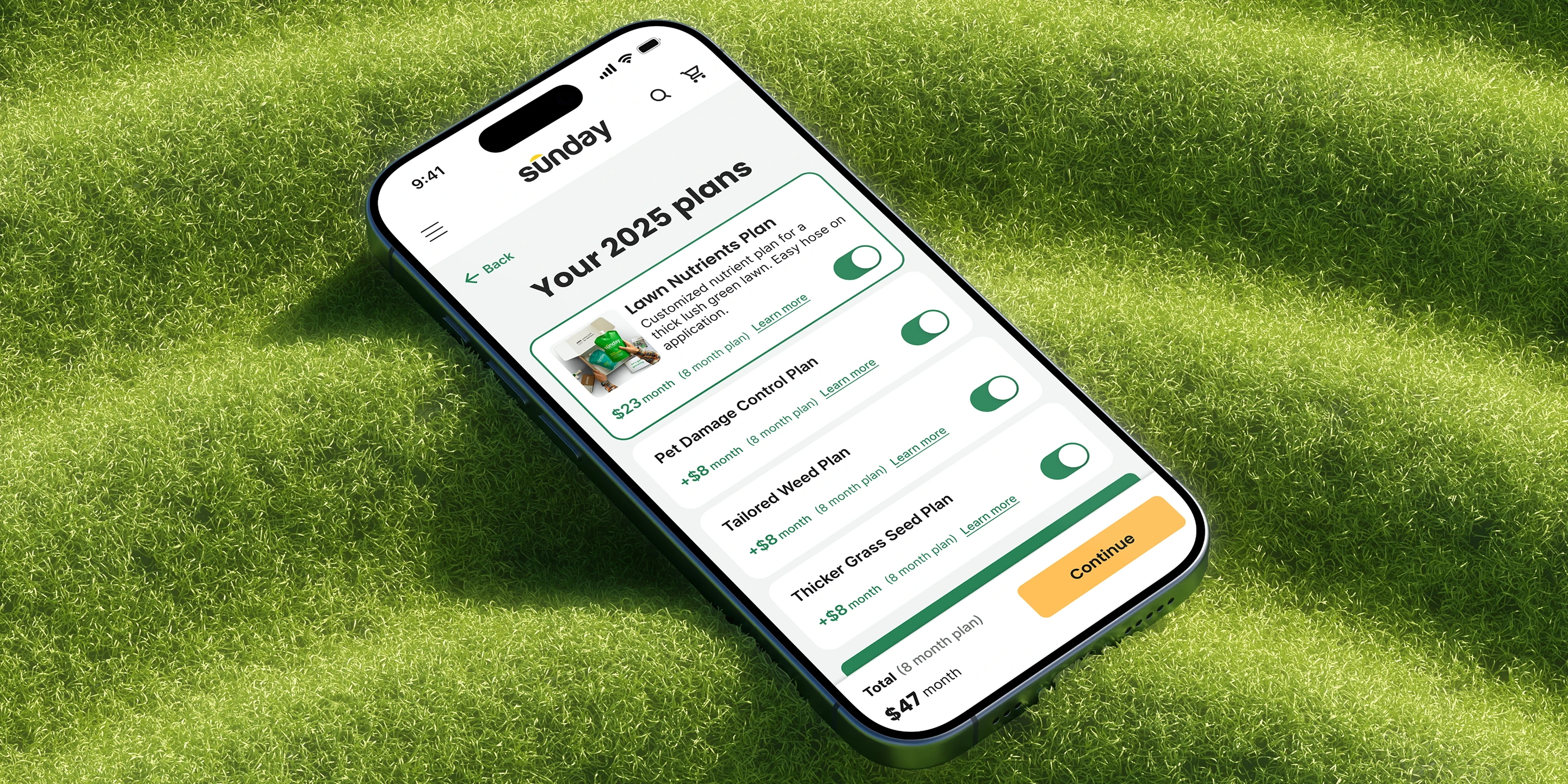 Sunday lawn care mobile app showing 2025 lawn plans on a smartphone resting on green grass